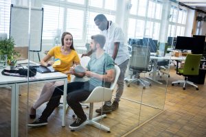 Male and female graphic designers interacting with each other Male and female graphic designers interacting with each other in office